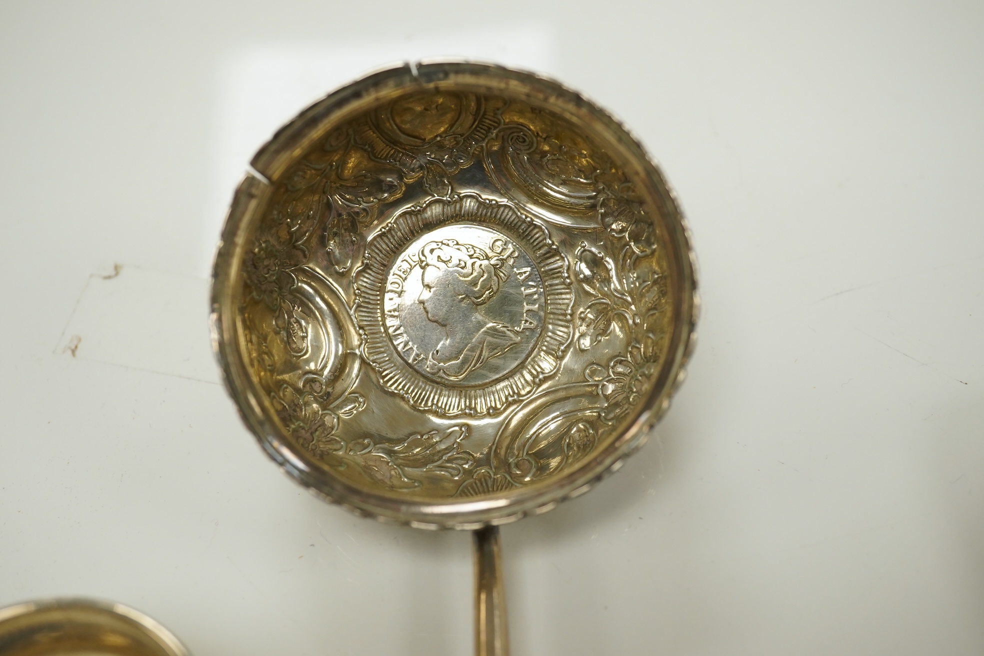 Small silver including a pair of napkin rings and two others, a Georgian sauce ladle and two similar dessert spoons, a fish slice, fork and an unmarked toddy ladle with inset coin bowl. Condition - poor to fair